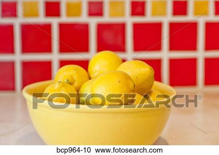 Bowl of lemons on counter with red tiles behind View Large Photo Image Stock Image - Bowl of lemons on counter with red tiles behind. Fotosearch