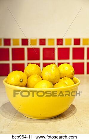 Bowl of lemons on counter with red tiles behind View Large Photo Image Stock Image - Bowl of lemons on counter with red tiles behind. Fotosearch