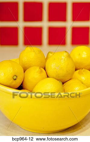Bowl of lemons on counter with red tiles behind View Large Photo Image Stock Image - Bowl of lemons on counter with red tiles behind. Fotosearch