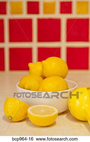 Bowl of lemons on counter with red tiles behind View Large Photo Image Stock Photograph - Bowl of lemons on counter with red tiles behind. Fotosearch