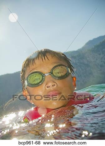 Boy coming up out of water View Large Photo Image Stock Photo - Boy coming up out of water. Fotosearch