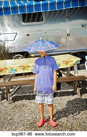 Boy in rain hat near airstream camper View Large Photo Image Stock Photograph - Boy in rain hat near airstream camper. Fotosearch