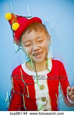 Boy in red costume with holiday lights View Large Photo Image Picture - Boy in red costume with holiday lights. Fotosearch