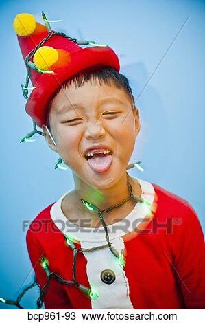 Boy in red costume with holiday lights View Large Photo Image Stock Image - Boy in red costume with holiday lights. Fotosearch