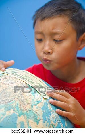 Boy placing 20 dollar bill on globe View Large Photo Image Stock Image - Boy placing 20 dollar bill on globe. Fotosearch