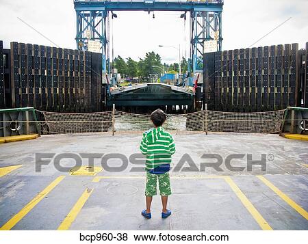 Boy standing on car deck of ferry View Large Photo Image Stock Photo - Boy standing on car deck of ferry. Fotosearch