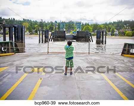 Boy standing on car deck of ferry View Large Photo Image Stock Photo - Boy standing on car deck of ferry. Fotosearch