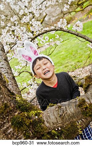 Stock Image - Boy wearing bunny ears. Fotosearch