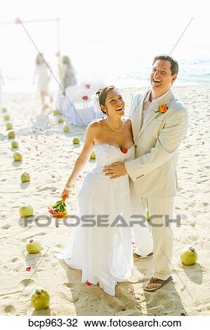 Bridal couple laughing on beach View Large Photo Image Stock Image - Bridal couple laughing on beach. Fotosearch