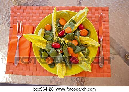 Stock Photo - Endive watercress and tomato salad on colorful mat. Fotosearch