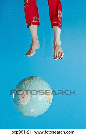 Stock Image - Globe and feet in air. Fotosearch