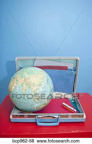 Stock Photo - Globe sitting inside open vintage briefcase. Fotosearch