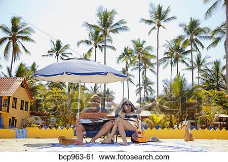 Stock Photography Of Hy Man And Woman In Beach Chairs With Hy Man And Woman In Beach Chairs With Guitars Dogs