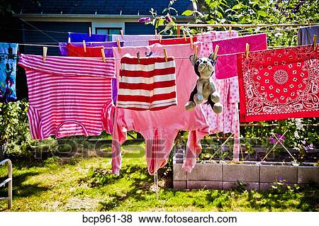 Stock Photo - Laundry and stuffed dog hanging on outdoor lines. Fotosearch
