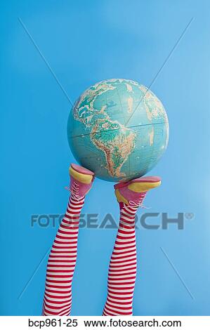 Legs in striped socks with colorful shoes holding globe View Large Photo Image Stock Photography - Legs in striped socks with colorful shoes holding globe. Fotosearch