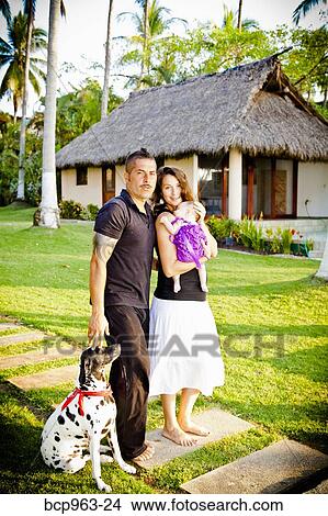Man and woman holding baby with dog outdoors View Large Photo Image Picture - Man and woman holding baby with dog outdoors. Fotosearch