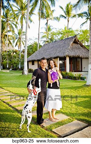 Man and woman holding baby with dog outdoors View Large Photo Image Stock Photography - Man and woman holding baby with dog outdoors. Fotosearch