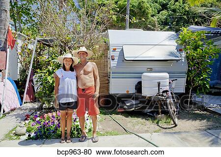 Man and woman standing in garden with camper View Large Photo Image Stock Image - Man and woman standing in garden with camper. Fotosearch