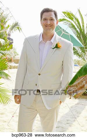 Man in white suit on beach View Large Photo Image Stock Photo - Man in white suit on beach. Fotosearch