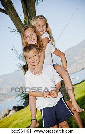 Stock Image - Outdoor portrait of three young children. Fotosearch