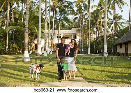 Portrait of young family in front of large house View Large Photo Image Stock Image - Portrait of young family in front of large house. Fotosearch