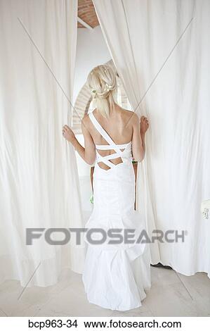 Rear view of bride peeking through curtains View Large Photo Image Picture - Rear view of bride peeking through curtains. Fotosearch