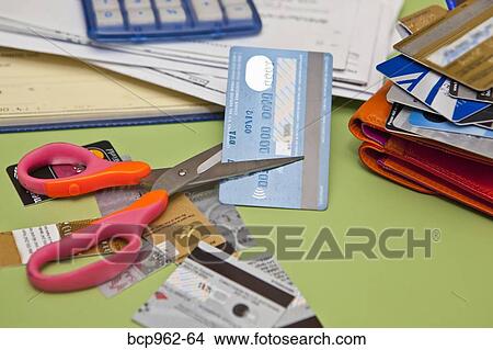 Scissors cutting up credit cards View Large Photo Image Picture - Scissors cutting up credit cards. Fotosearch