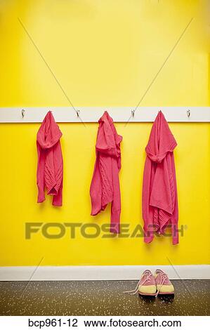 Sweaters and leash on hooks with dog and shoes View Large Photo Image Stock Image - Sweaters and leash on hooks with dog and shoes. Fotosearch