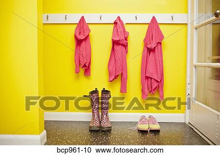 Sweaters on hooks with boots and shoes below View Large Photo Image Stock Image - Sweaters on hooks with boots and shoes below. Fotosearch