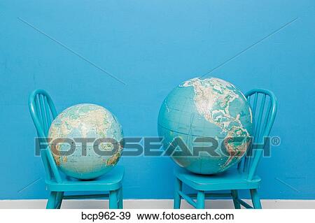 Two globes placed on two chairs facing each other View Large Photo Image Stock Photo - Two globes placed on two chairs facing each other. Fotosearch