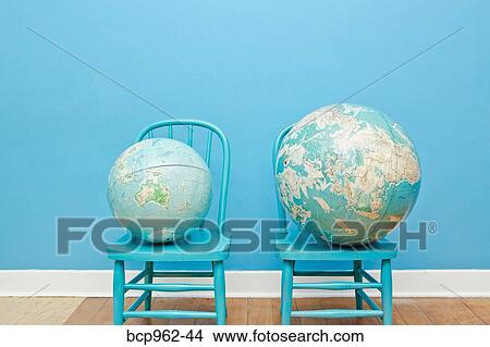 Two globes placed on two chairs View Large Photo Image Picture - Two globes placed on two chairs. Fotosearch