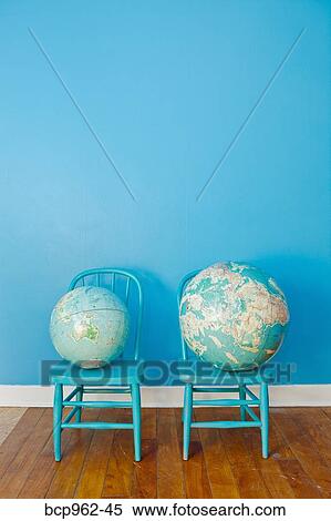 Two globes placed on two chairs View Large Photo Image Stock Photography - Two globes placed on two chairs. Fotosearch