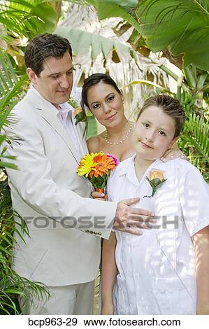 Wedding couple with boy under palms View Large Photo Image Stock Photo - Wedding couple with boy under palms. Fotosearch