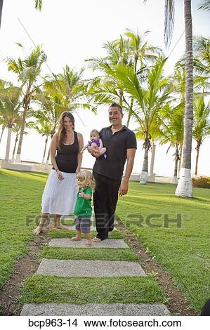 Woman and man holding baby with young boy outdoors View Large Photo Image Picture - Woman and man holding baby with young boy outdoors. Fotosearch