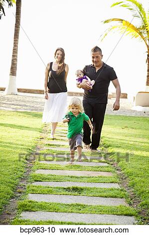 Woman and man holding baby with young boy outdoors View Large Photo Image Stock Image - Woman and man holding baby with young boy outdoors. Fotosearch