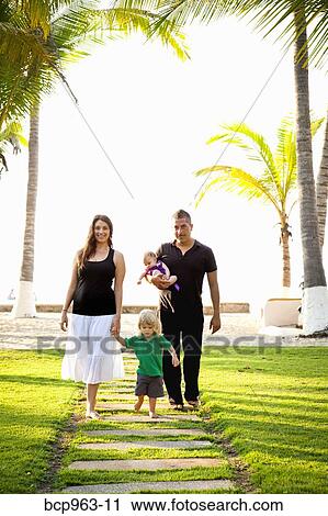 Woman and man holding baby with young boy outdoors View Large Photo Image Stock Image - Woman and man holding baby with young boy outdoors. Fotosearch