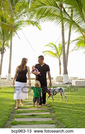Woman and man holding baby with young boy outdoors View Large Photo Image Stock Image - Woman and man holding baby with young boy outdoors. Fotosearch