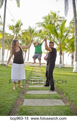 Woman and man holding baby with young boy outdoors View Large Photo Image Stock Photography - Woman and man holding baby with young boy outdoors. Fotosearch