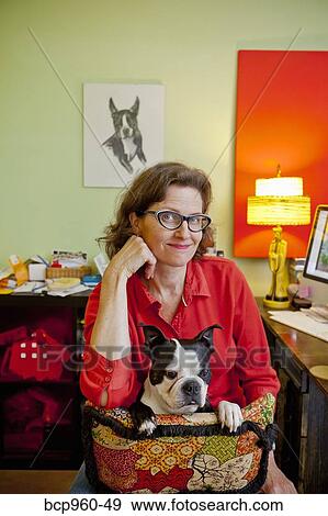 Woman at home office desk with dog View Large Photo Image Stock Photo - Woman at home office desk with dog. Fotosearch
