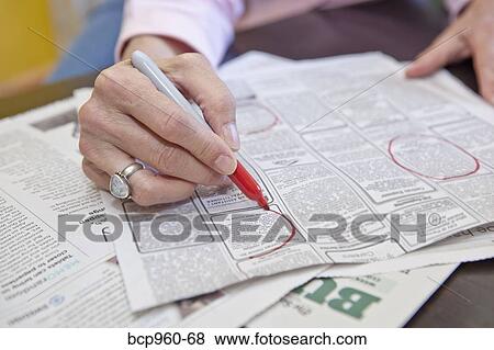 Woman circling employment ads in paper View Large Photo Image Stock Photo - Woman circling employment ads in paper. Fotosearch