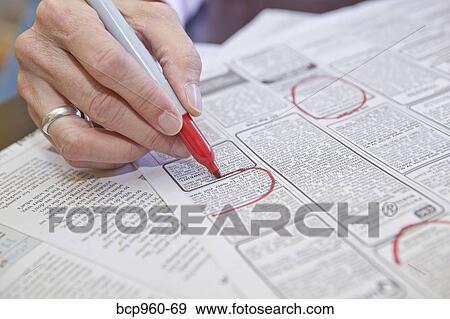 Woman circling employment ads in paper View Large Photo Image Stock Photo - Woman circling employment ads in paper. Fotosearch