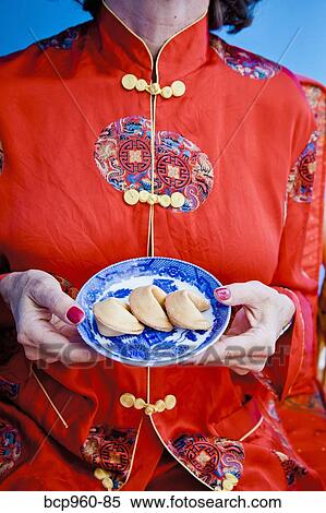 Woman holding plate of fortune cookies View Large Photo Image Stock Photography - Woman holding plate of fortune cookies. Fotosearch