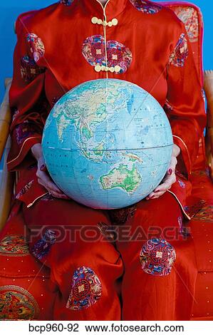 Woman in Chinese pajamas holding globe View Large Photo Image Stock Image - Woman in Chinese pajamas holding globe. Fotosearch