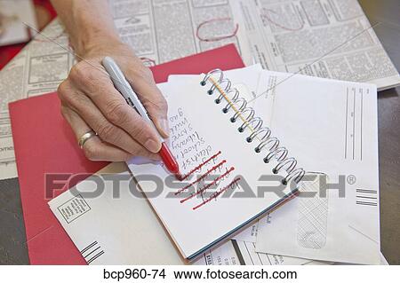 Woman making list in small notebook View Large Photo Image Picture - Woman making list in small notebook. Fotosearch