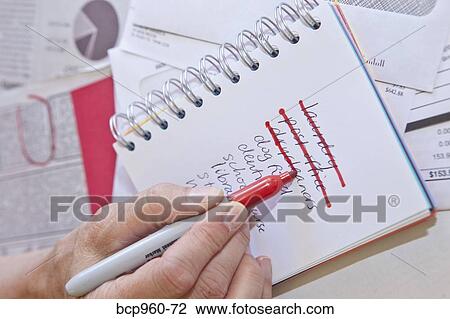 Woman making list in small notebook View Large Photo Image Stock Image - Woman making list in small notebook. Fotosearch