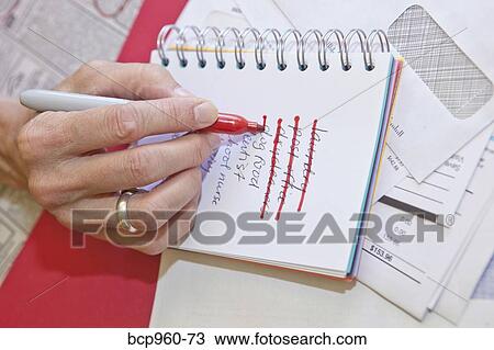 Woman making list in small notebook View Large Photo Image Stock Image - Woman making list in small notebook. Fotosearch