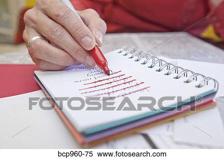 Woman making list in small notebook View Large Photo Image Stock Photography - Woman making list in small notebook. Fotosearch