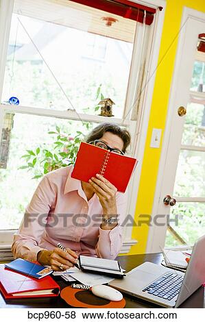 Stock Photo - Woman paying bills. Fotosearch