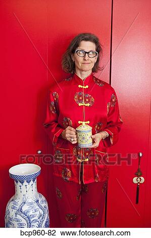 Woman wearing red silk Chinese pajamas View Large Photo Image Stock Image - Woman wearing red silk Chinese pajamas. Fotosearch