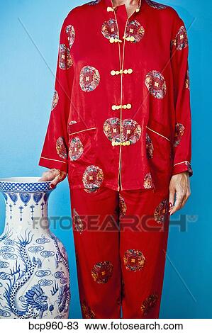 Woman wearing red silk Chinese pajamas View Large Photo Image Stock Image - Woman wearing red silk Chinese pajamas. Fotosearch
